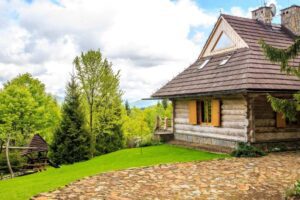 A house with a stone floor and a wooden roof.