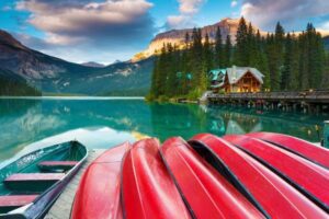 A boat is parked on the shore of a lake.