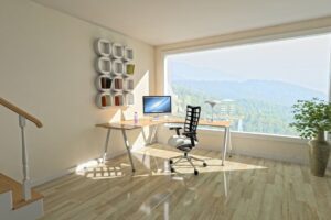 A computer desk with a laptop on top of it.