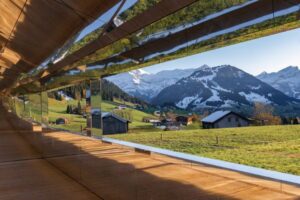 A view of mountains from inside a window.